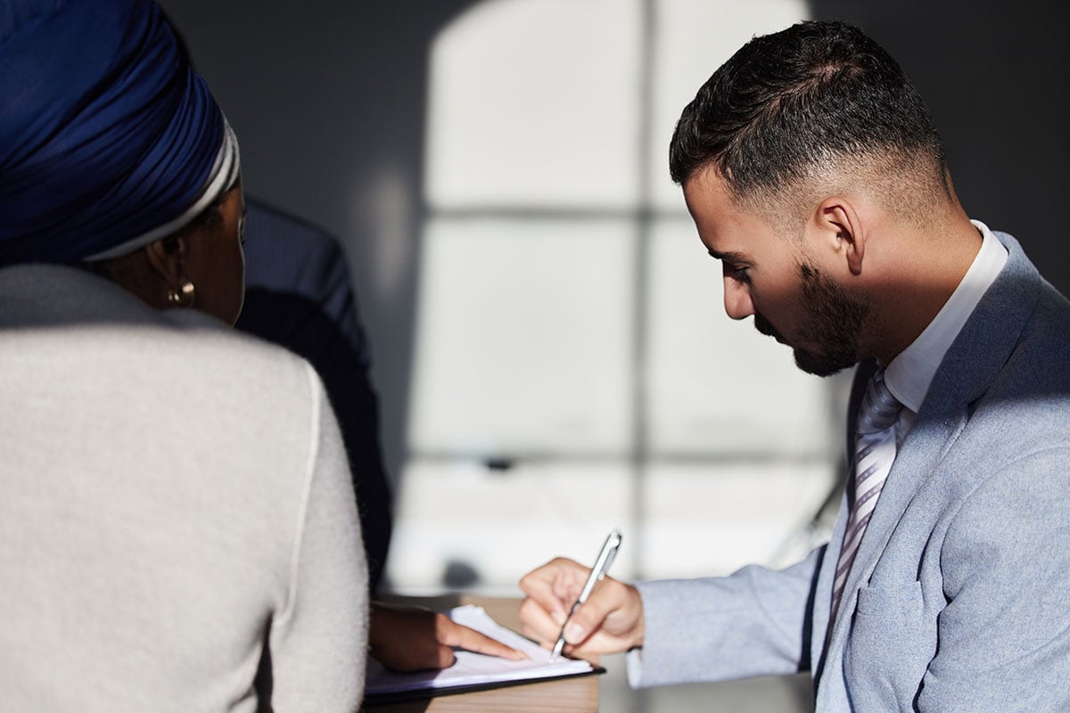 couple signing documents